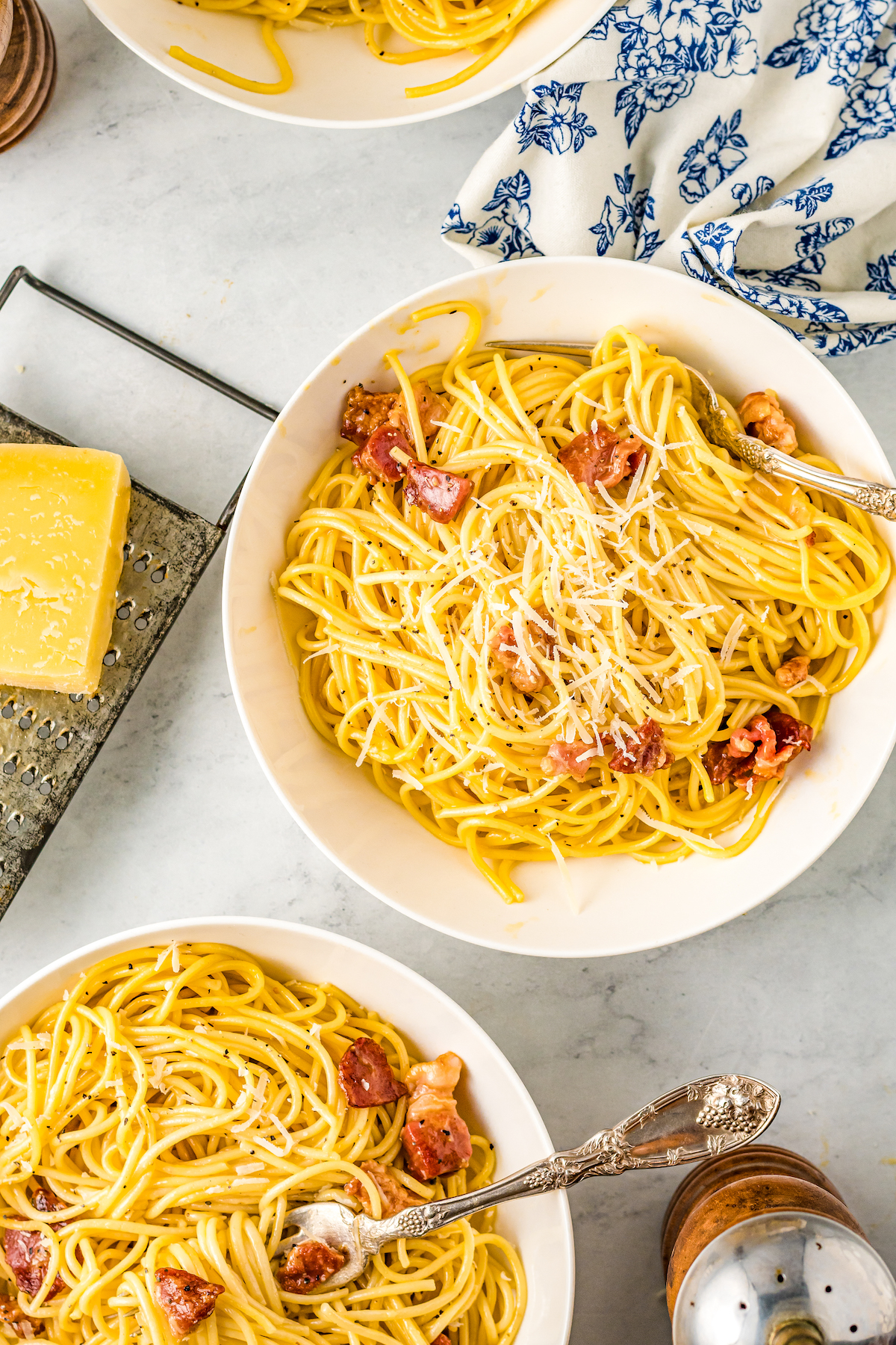 Two bowls of spaghetti carbonara. 