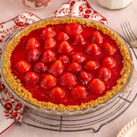 A pie with strawberry and jello topping.