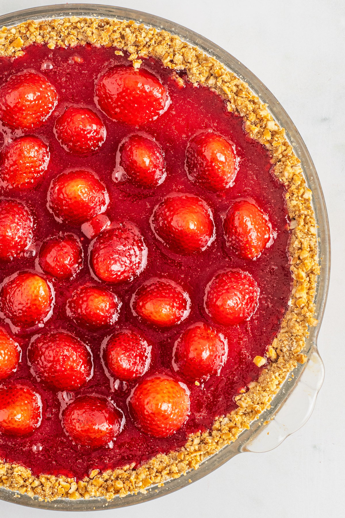 Overhead shot of an icebox pie with strawberry topping.