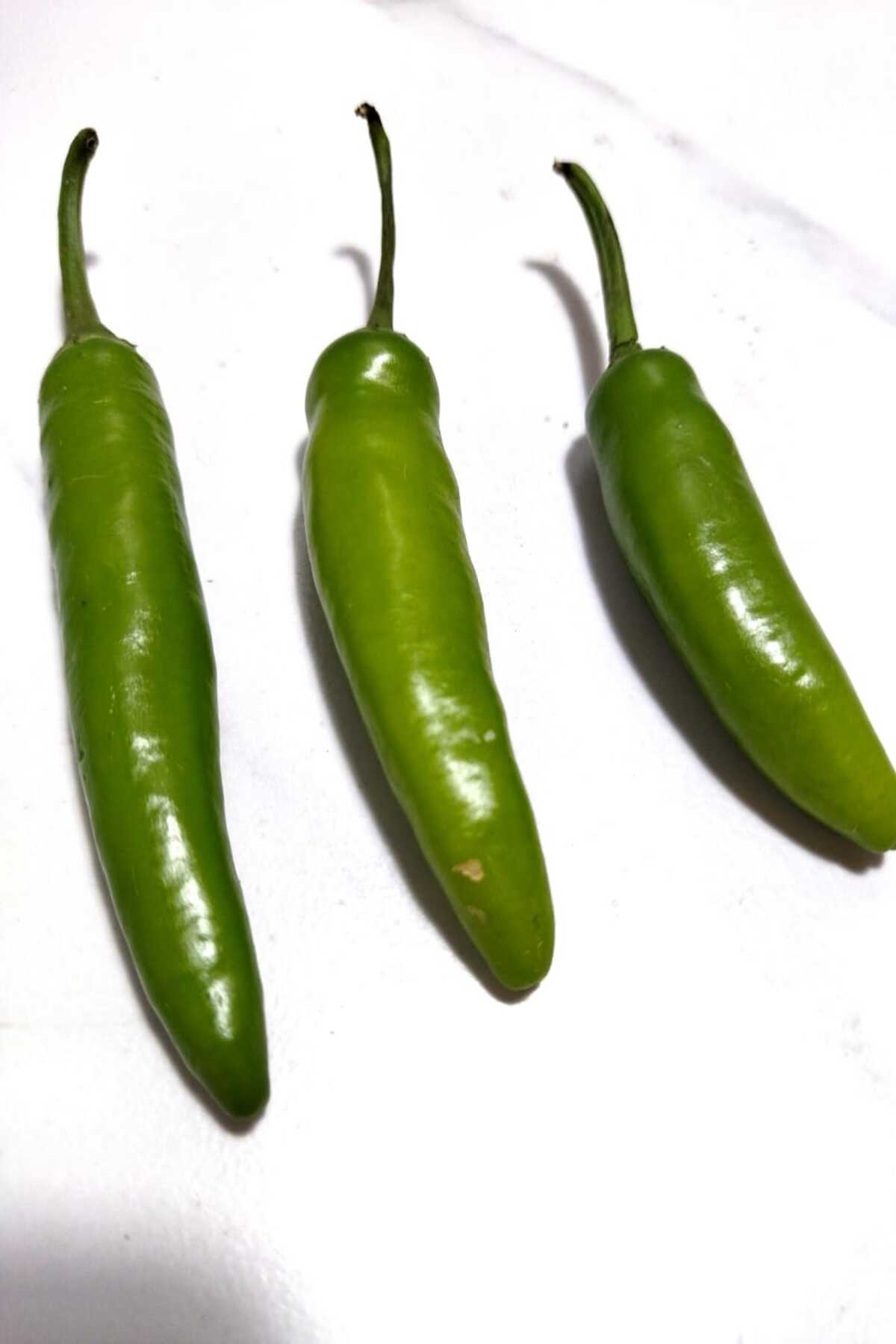 Three serrano peppers side by side. 