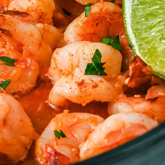 Garlic shrimp in a skillet with lime and fresh cilantro.