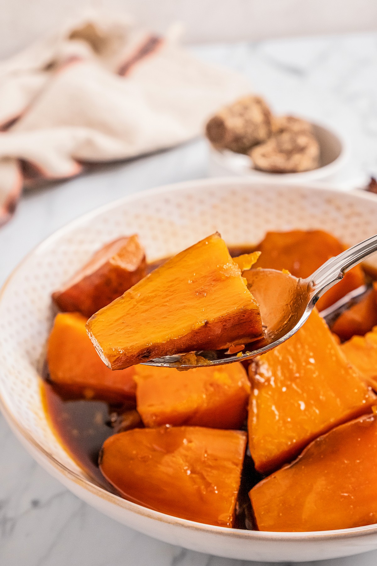 Candied sweet potatoes on a spoon.