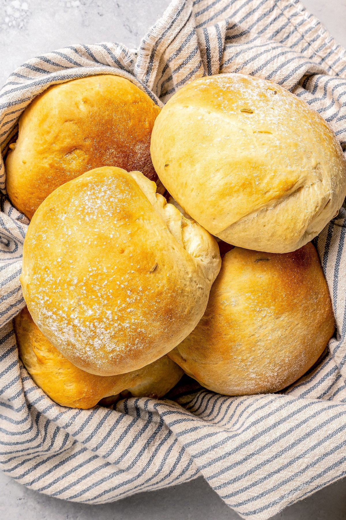 Close-up of cemitas in a cloth-lined bread basket.