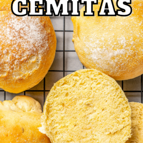 Cemitas on a cooling rack with one sliced in half to show the inside.