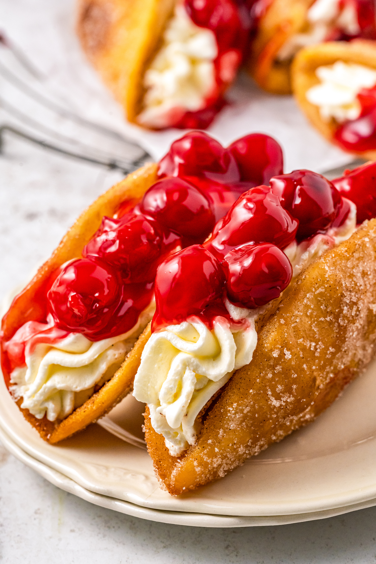 Two dessert tacos on a plate.