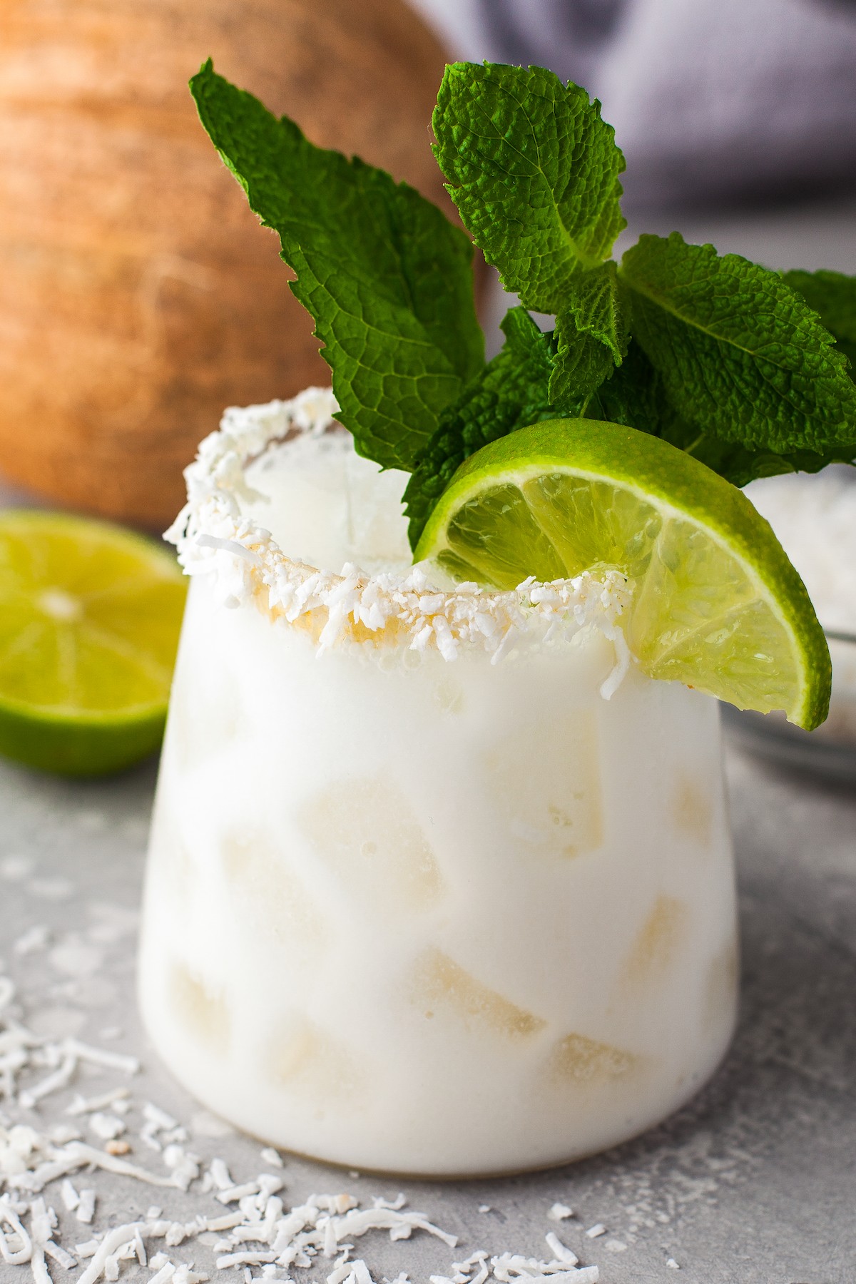 Close-up of a tropical margarita with a coconut rim. 