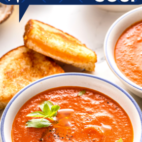 A bowl of copycat panera tomato soup with basil on top.