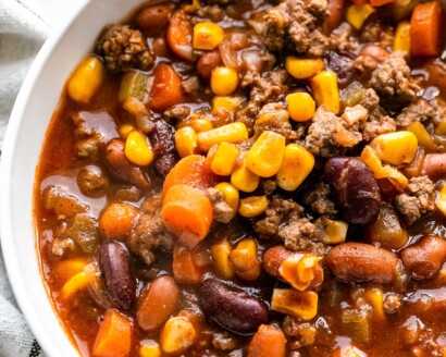 Overhead shot of a bowl of chili with corn and carrots.