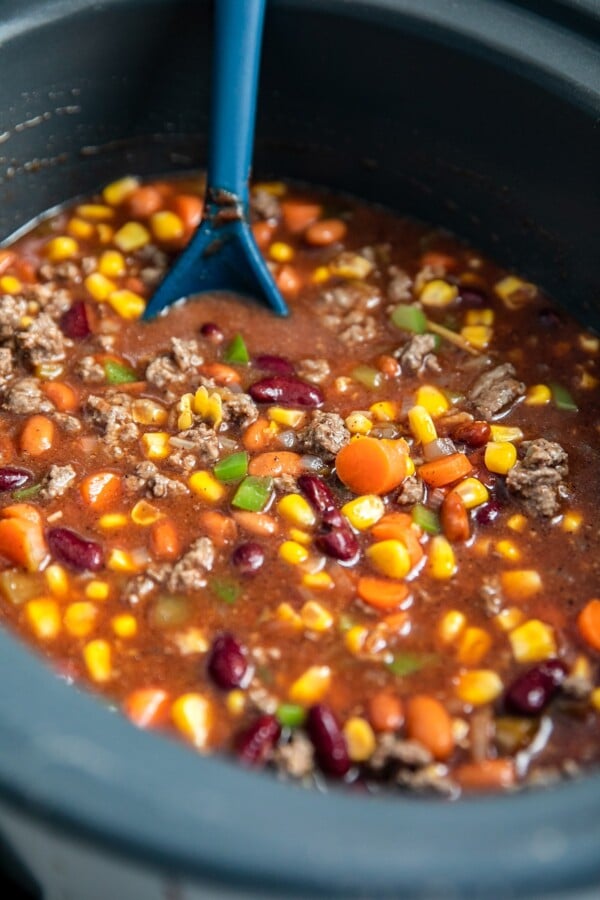 Stirring chili ingredients.