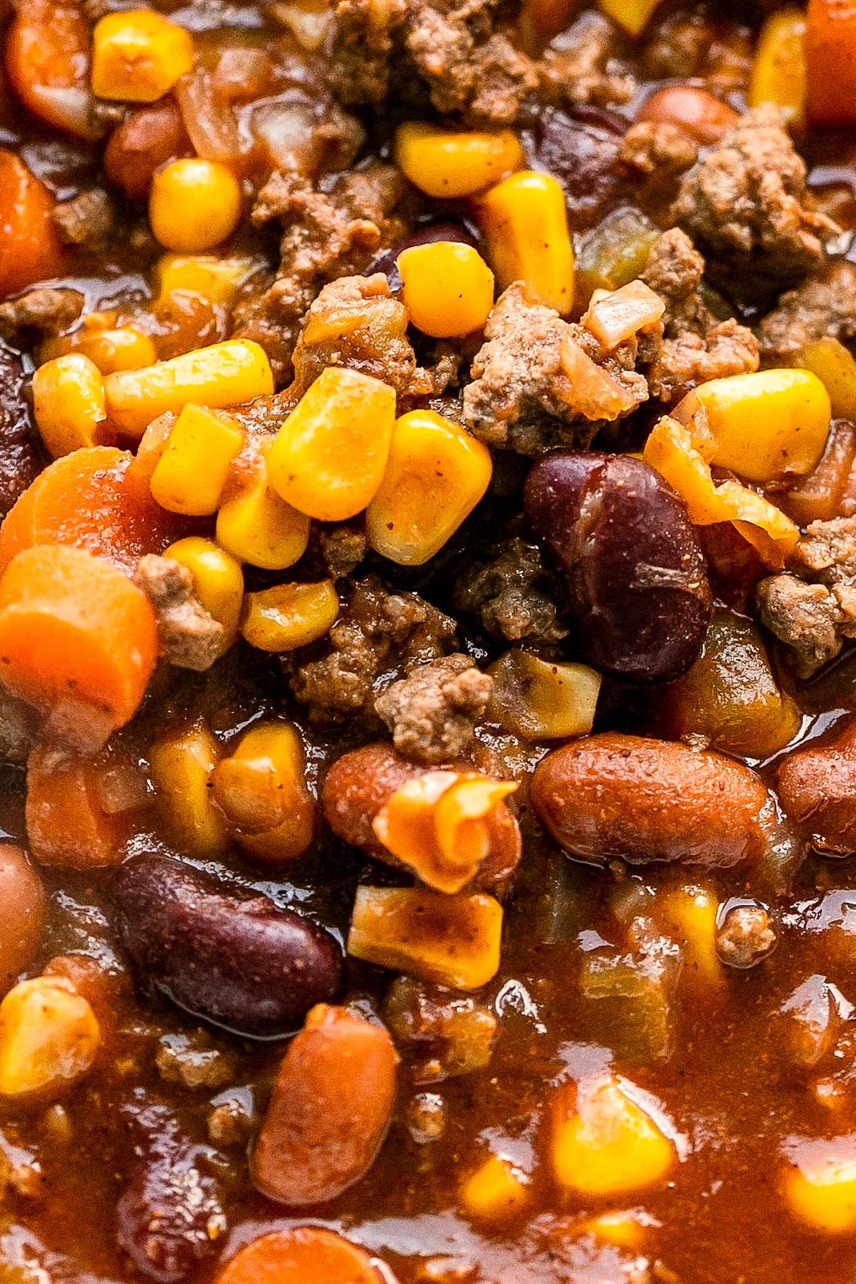 Close-up shot of chili with corn, beans, and beef.