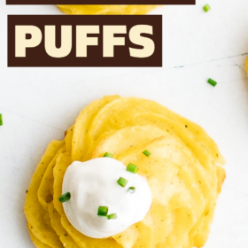 Duchess potatoes with sour cream and chives on top.