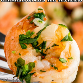 Mexican garlic shrimp on a fork with fresh cilantro on top.