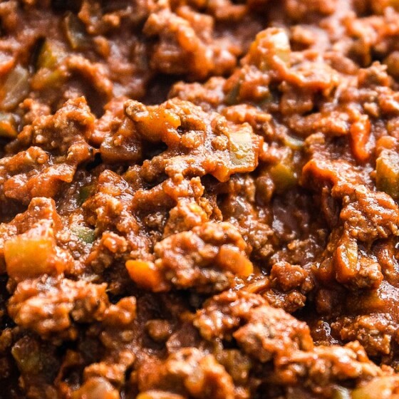 Close-up shot of chili in a cast-iron skillet.