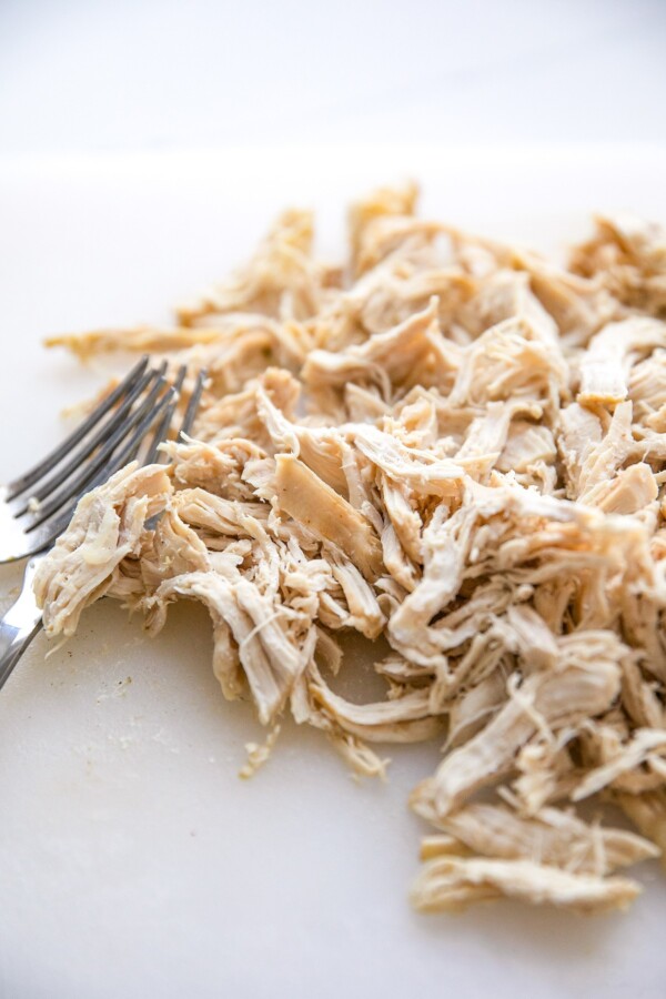 Shredded chicken on a white surface