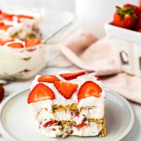 A square of strawberry icebox cake on a small white plate.