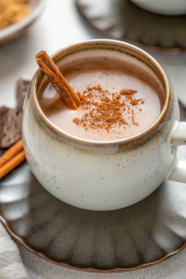 Atole made with chocolate with ground cinnamon on top.