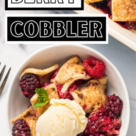 A bowl of classic berry cobbler with vanilla ice cream on top.