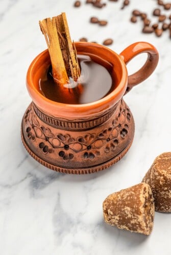 Café de Olla in a clay coffee mug with a cinnamon sitck.