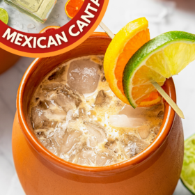 A glass of Mexican Cantaritos with lime and orange garnish.