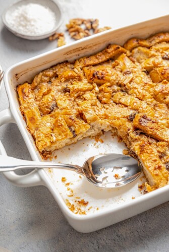 Capirotada in a casserole dish with a spoon.