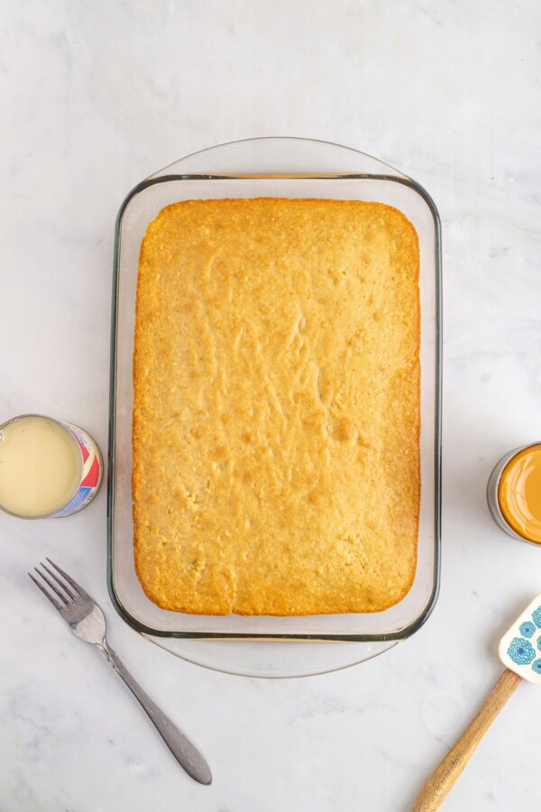 Baked vanilla cake in a glass dish.