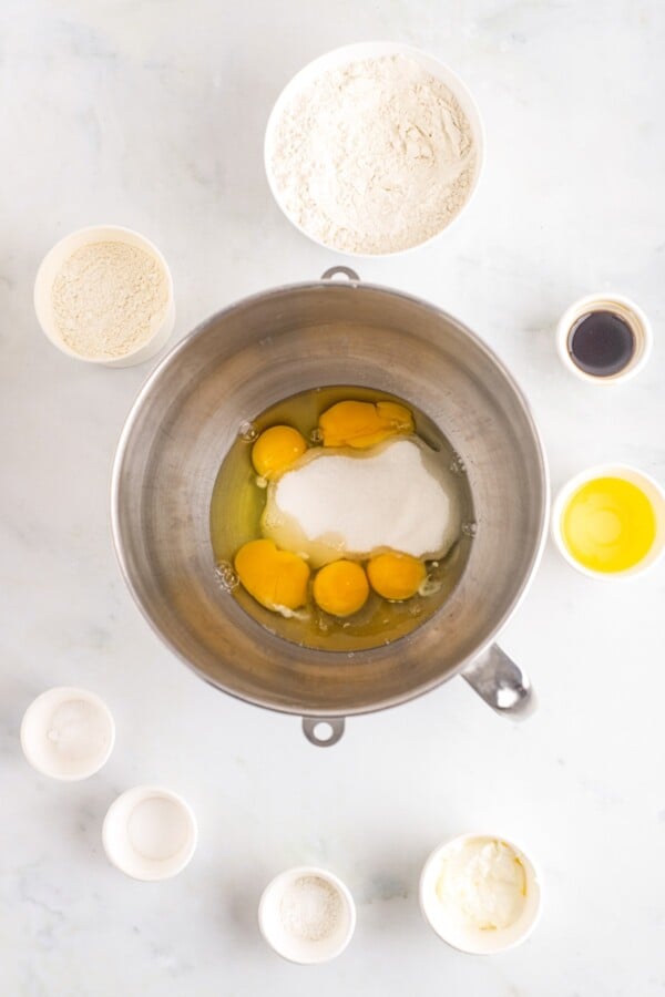 Eggs, sugar, and other ingredients in a mixing bowl.