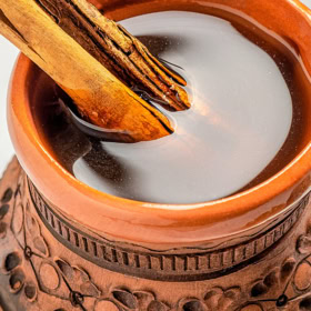 Café de Olla in a mug with a cinnamon stick.