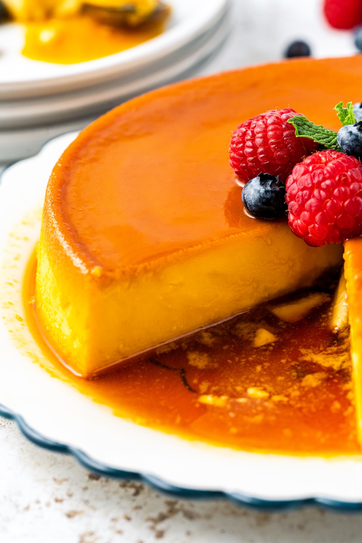 Sliced queso flan with caramel sauce. 