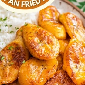 Sweet plantains on a plate with salt and fresh herbs sprinkled on top.