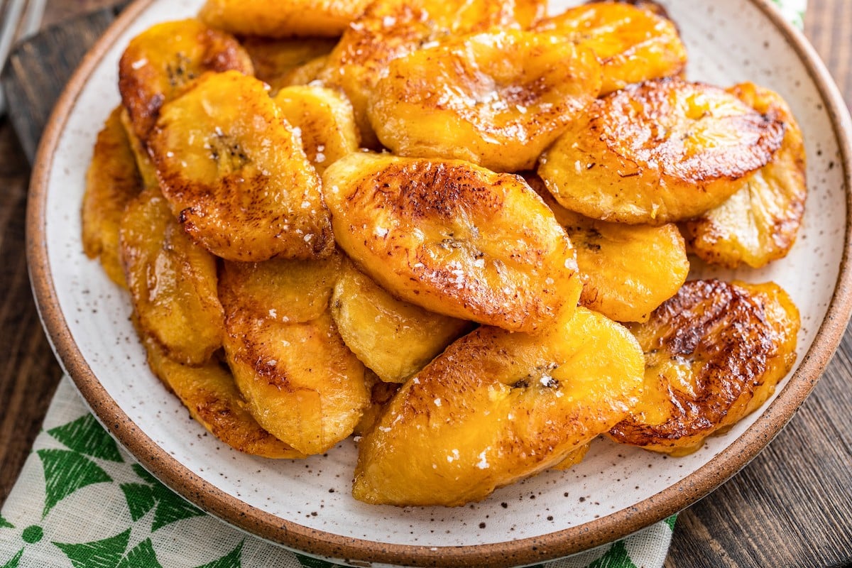 Fried sweet plantains on a plate with salt on top.