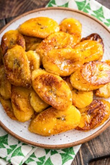 A plate filled with Maduros, sweet plantains, with sea salt sprinkled on top.