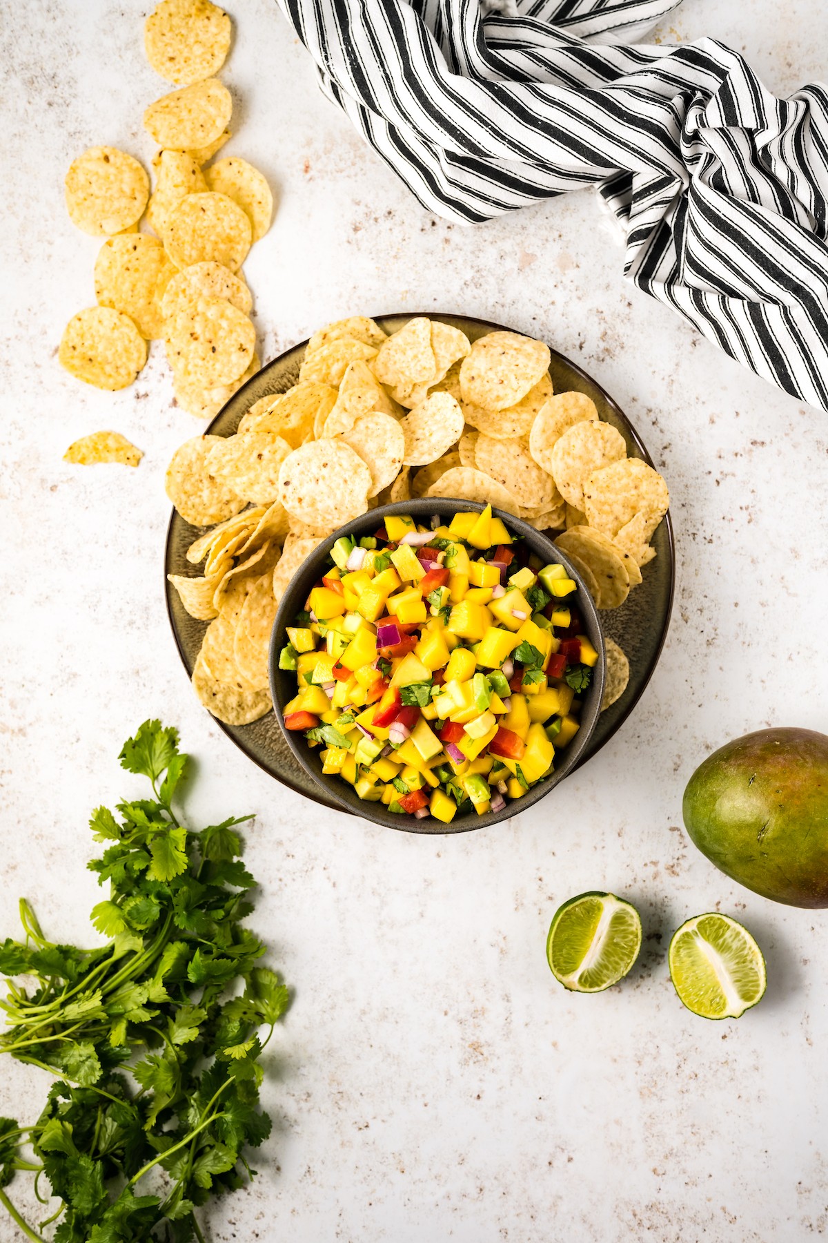 Corn chips with mango salsa in a bowl. 