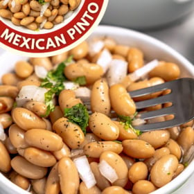 A bowl of Frijoles de la Olla with a fork picking up a bite.