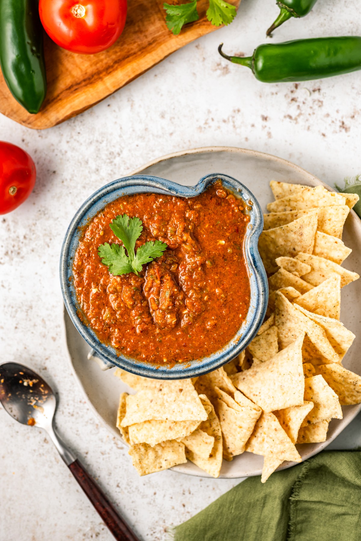 Bowl of salsa with corn chips in the side. 