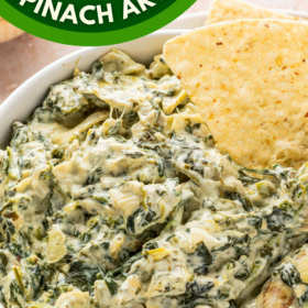 A bowl of Spinach Artichoke Dip with tortilla chips in it.