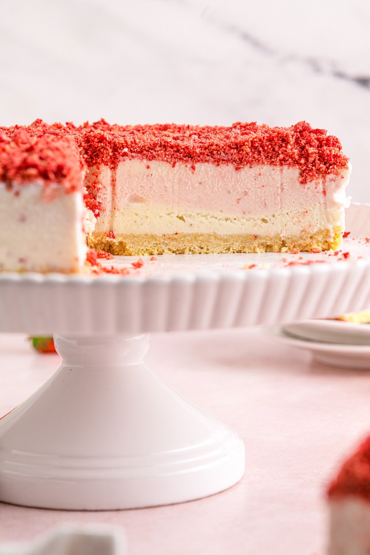 An ice cream cake with slices removed, showing the layers inside.