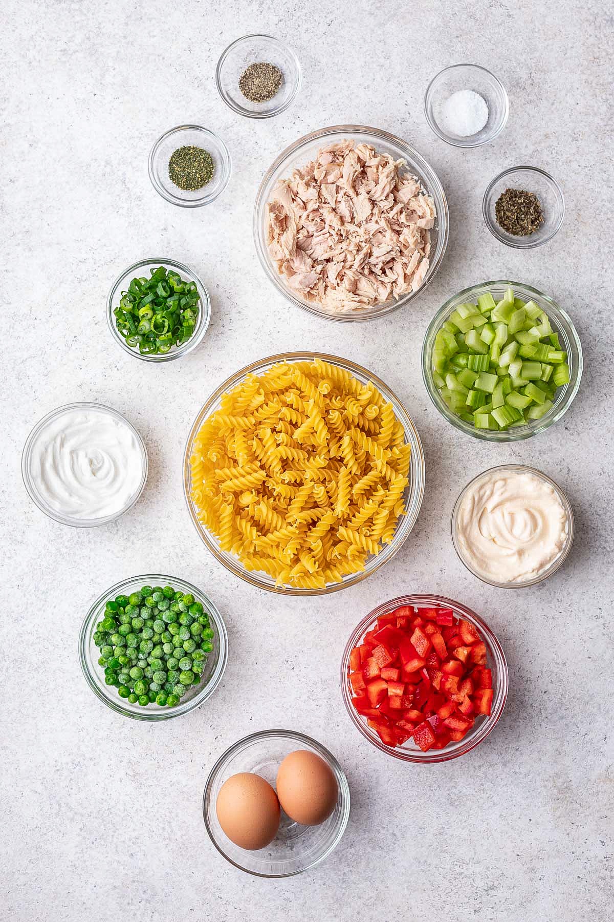 Ingredients for tuna pasta salad, measured and arranged on a work surface.