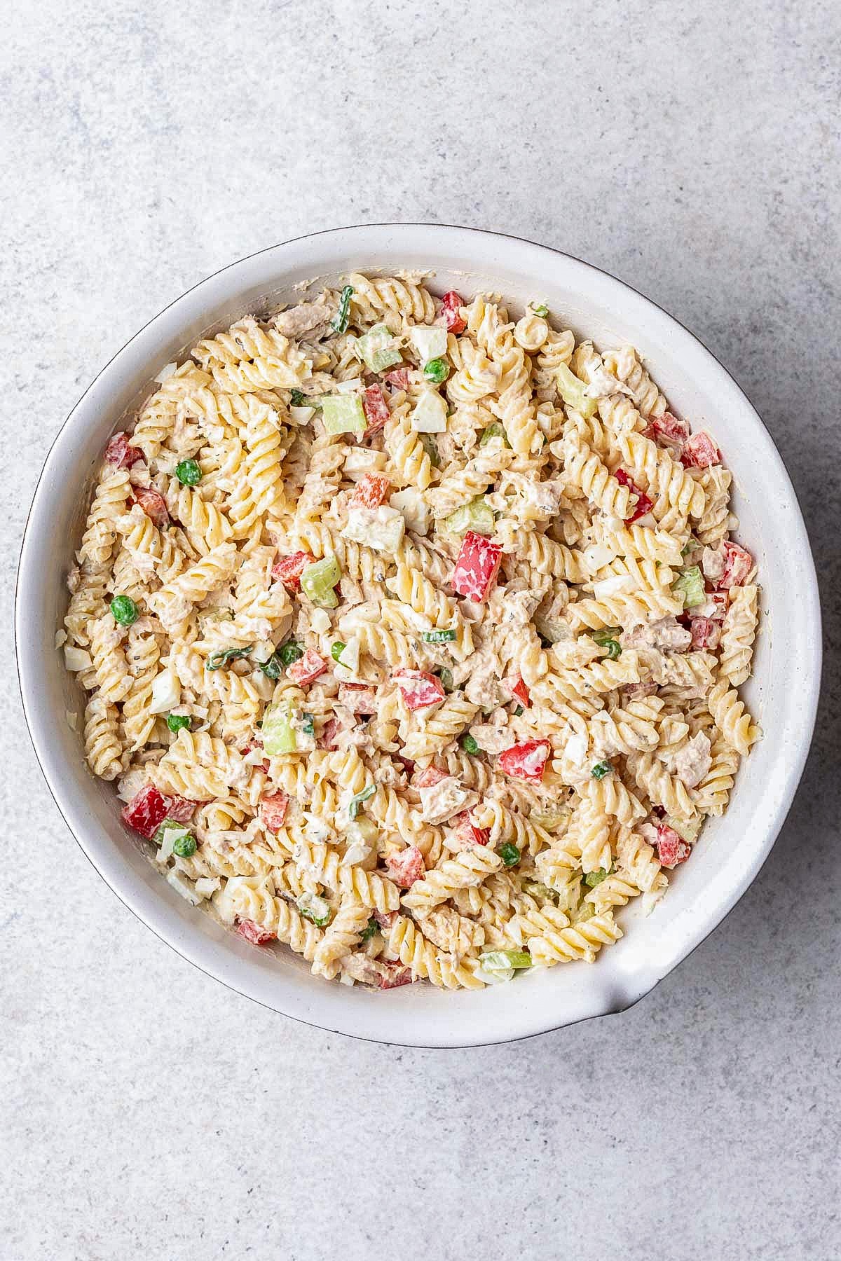 Creamy tuna pasta salad with peppers, celery, and peas.