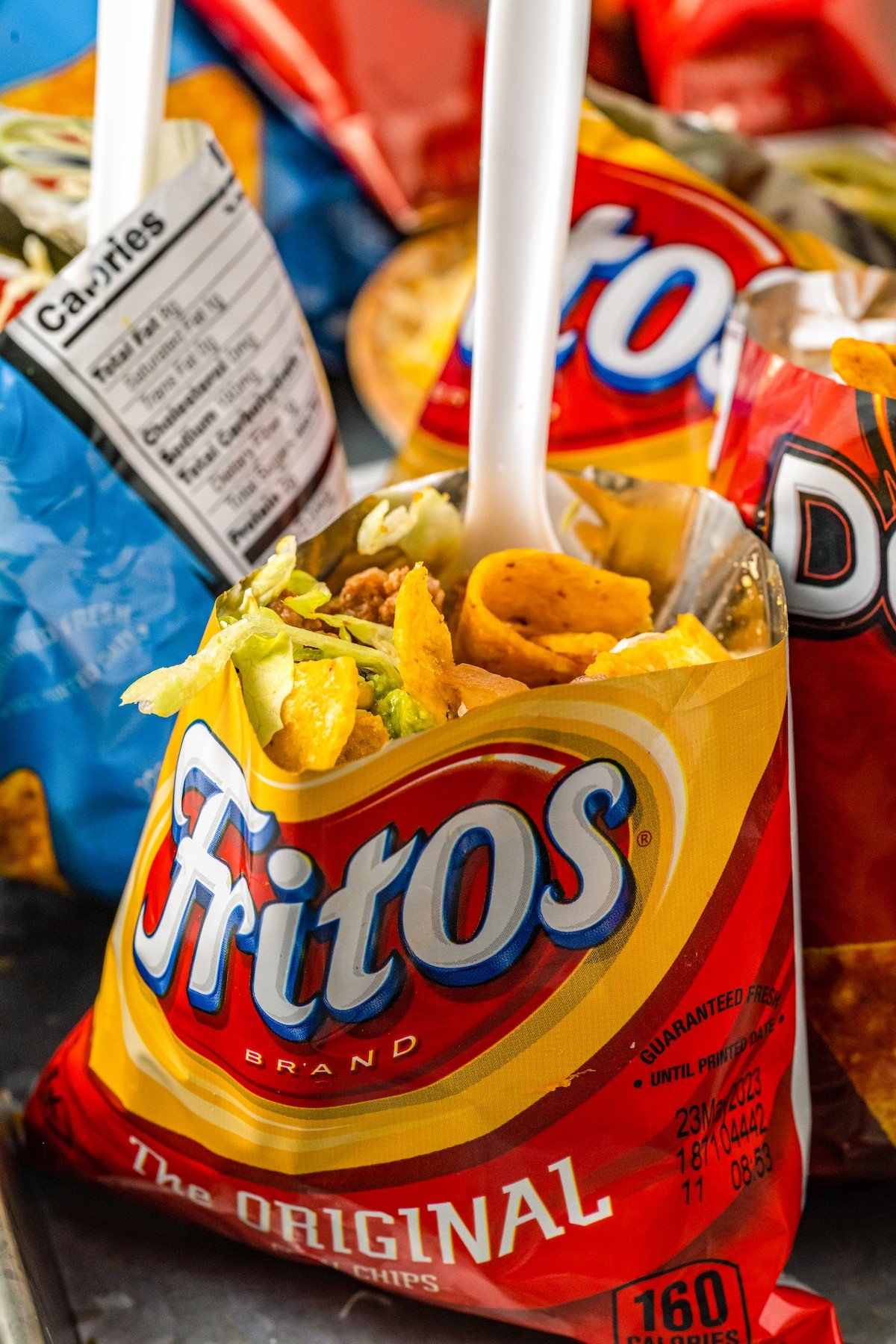 A plastic spoon in a taco-in-a-bag made with Fritos.