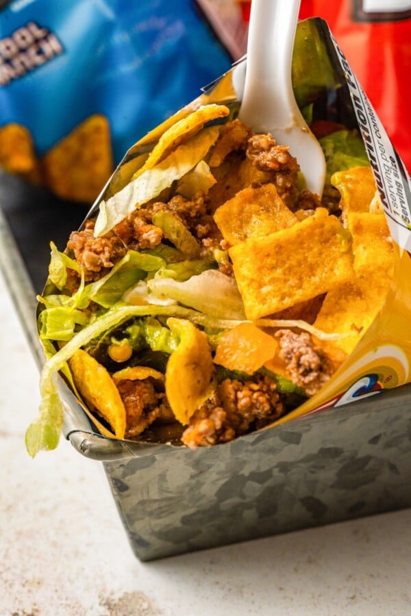 Overhead shot of a walking taco with a plastic spoon in it.