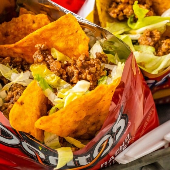 Walking taco made with Doritos, shredded lettuce, and more.