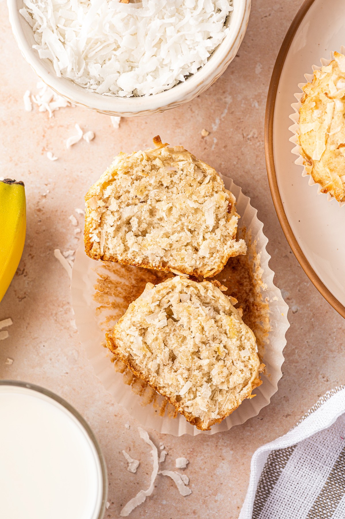 A coconut banana muffin sliced in half to see the inside.