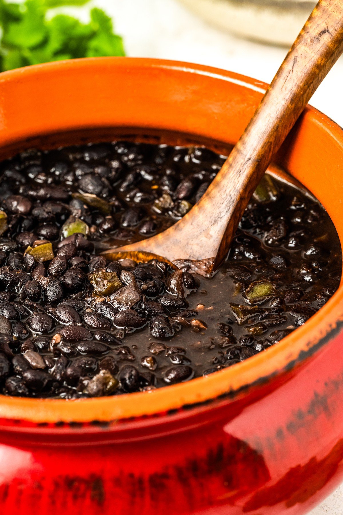 Clay pot full of Cuban style black beans. 