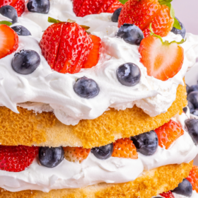 Angle food cake sliced into layers and stuffed with berries and whipped cream.