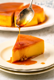Drizzling caramel over a slice of flan.