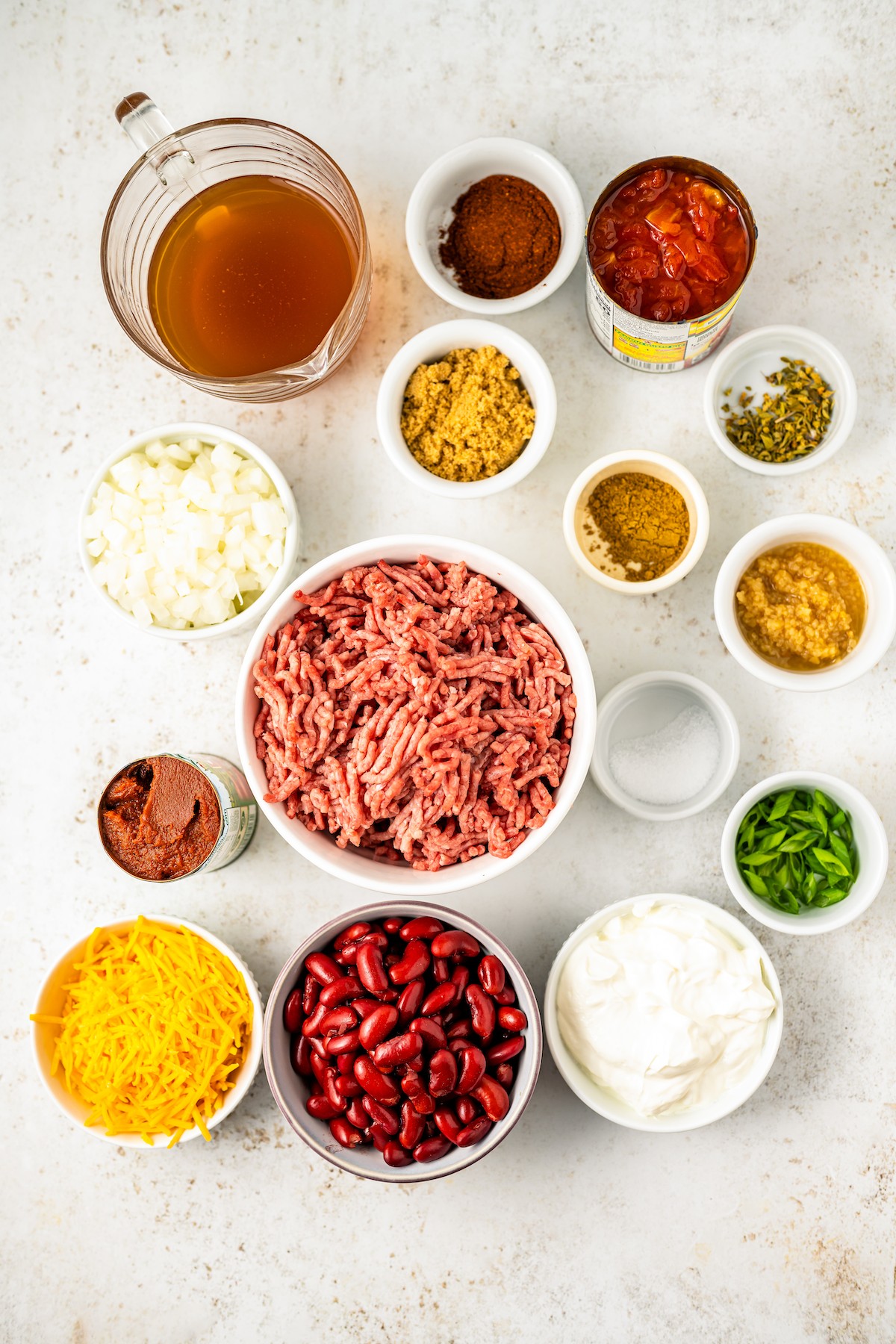 Ingredients for hot dog chili, measured and arranged on a work surface.