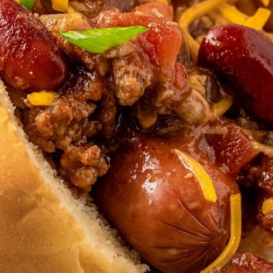 Close-up of hot dogs with homemade hot dog chili on top.