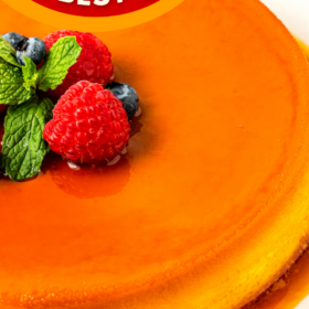 A slice of queso flan on a plate and a large flan on a serving plate.