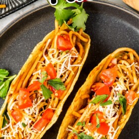 Two spaghetti tacos on a plate.