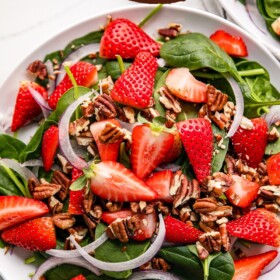 Spinach Strawberry Salad with pecans and red onion.